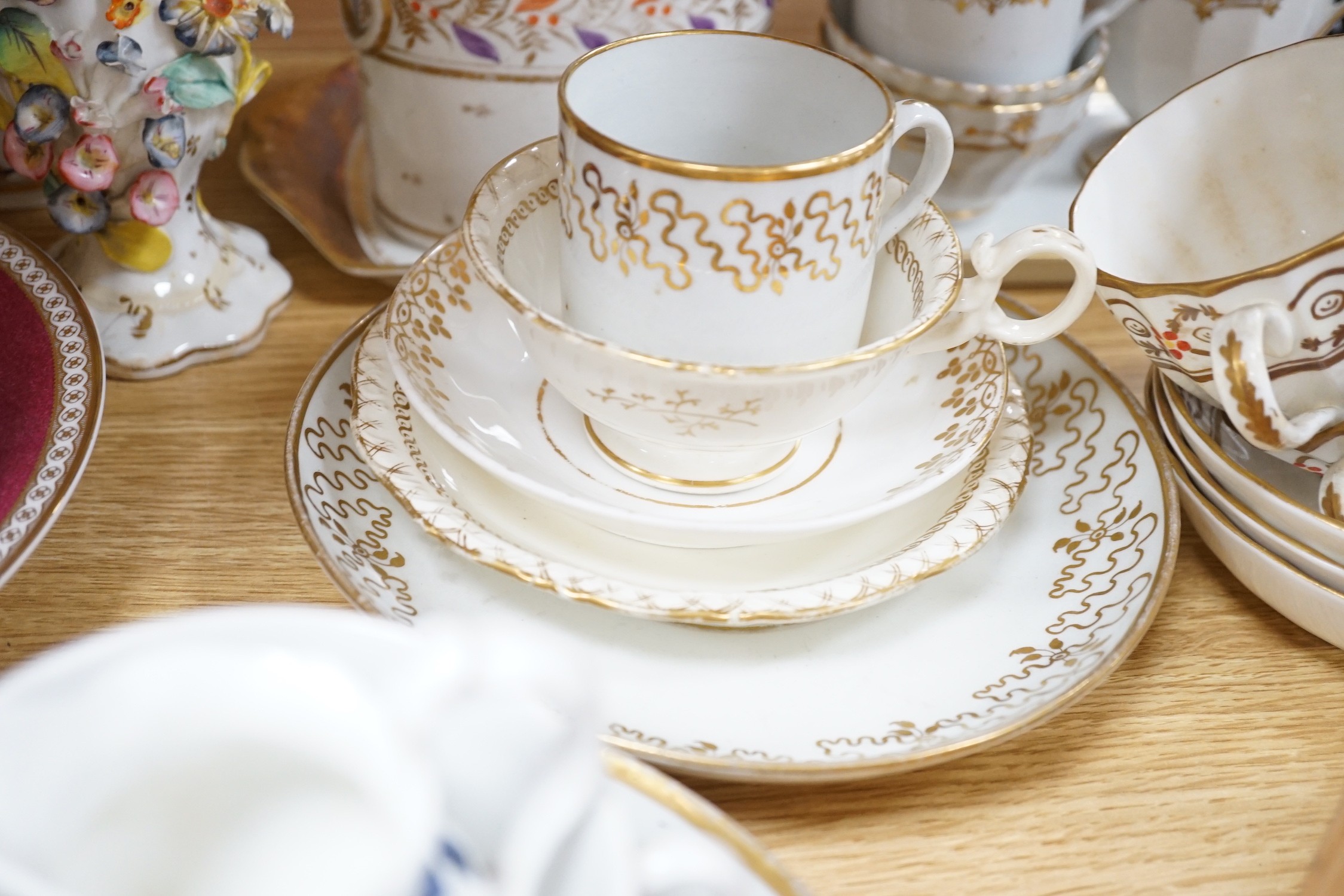 A large collection of mixed 19th century tea ware, a Staffordshire flat back, floral encrusted vase